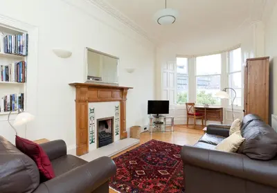 a living room with a couch and a fireplace at Mardale Crescent - 380 in Edinburgh
