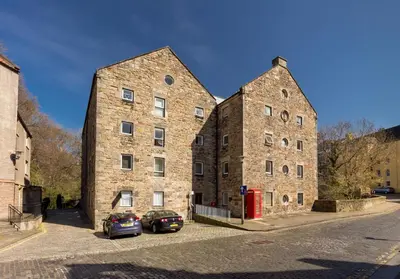 two large brick buildings with cars parked in front of them at Dean Path - 400 in Edinburgh
