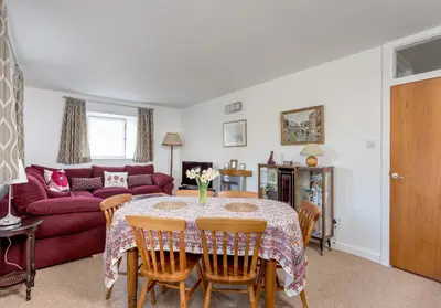 a living room with a table and a red couch at Dean Path - 400 in Edinburgh