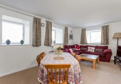 a living room with a table and a couch at Dean Path - 400 in Edinburgh