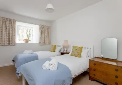 two beds in a room with a tv at Dean Path - 400 in Edinburgh