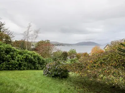 a garden with a view of the water at East Firwood in Rothesay