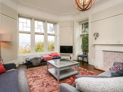 a living room with a couch and a table at East Firwood in Rothesay