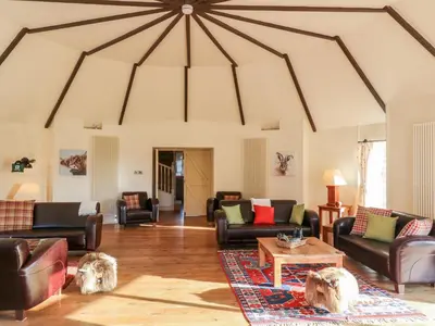 a large living room with couches and a table at The Roundhouse in Auchterarder