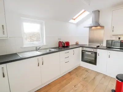 a kitchen with white cabinets and a sink at 1 Alpine Place in Thornhill