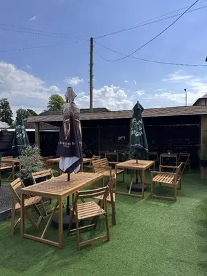 a group of tables and chairs with umbrellas at Glendevon Hotel in Auchterarder