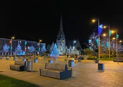 a park with christmas lights in a city at night at The Flat In The Square in Helensburgh
