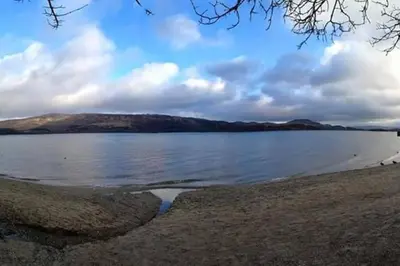 a large body of water with mountains in the background at Broomfield Cottage South Luss in Glasgow