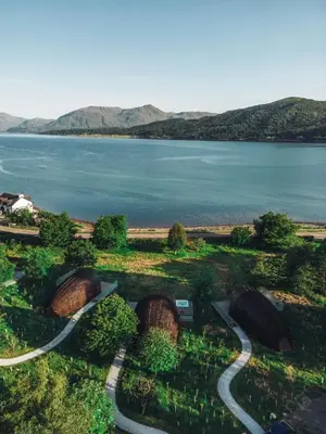 an aerial view of a lake with mountains in the background at SeaBeds - Luxury Lookouts with Hot Tubs in Glencoe