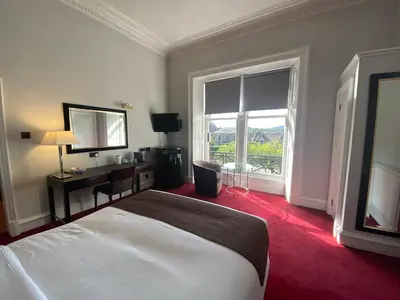 a hotel room with a bed and a large window at No6 West Coates in Edinburgh