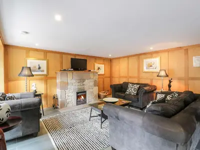 a living room with two couches and a fireplace at Cloncaird Castle Estate Cottages in Maybole