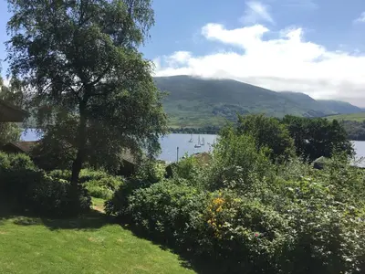 a view of a lake with boats in the water at Cosy Modern Nordic Lodge w/ Loch View & Log Burner in Lochearnhead