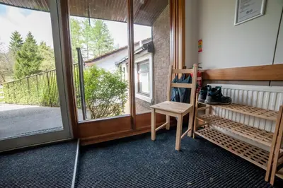 a room with a chair and a large window at Crianlarich Youth Hostel in Crianlarich
