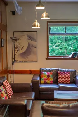 a living room with a couch and a window at Crianlarich Youth Hostel in Crianlarich