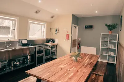 a kitchen with a wooden table in the middle of it at Boreland Loch Tay in Aberfeldy