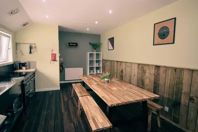 a kitchen with a wooden table with benches in it at Boreland Loch Tay in Aberfeldy