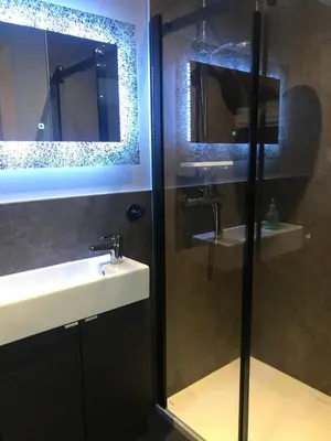 a bathroom with a sink and a glass shower at The Shack & Pods at Inchree in Corran