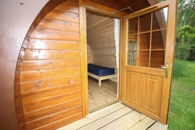 an entrance to a sauna with a wooden door at Posh Pod in Tyndrum