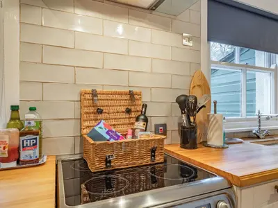 a basket sitting on top of a stove in a kitchen at Barjols Cottage - Uk30096 in Wiston