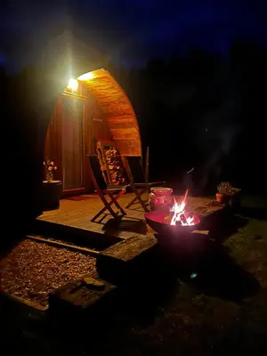 a fire pit in front of a tent at night at Stoneymollan over Loch Lomond in Balloch