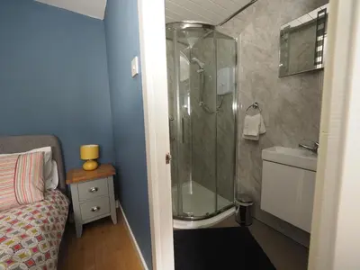 a bathroom with a shower and a toilet and a sink at Arrochar Alps Apartment in Arrochar