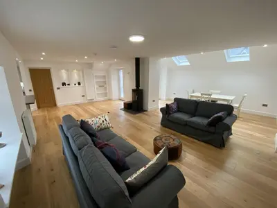 a living room with two couches and a table at The Smiddy House in Auchterarder