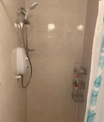 a shower with a phone in a bathroom at The Clan Boyd Room in Kilmarnock