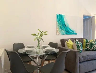 a living room with a table and a couch at Hillington Central in Glasgow