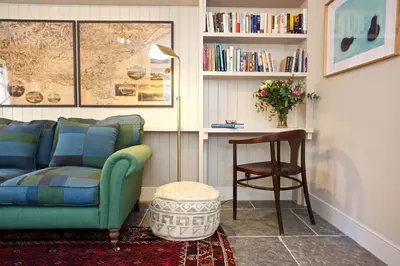 a living room with a couch and a table at Ross Lodge in Comrie