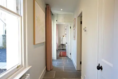 a hallway with a door and a tile floor at Ross Lodge in Comrie