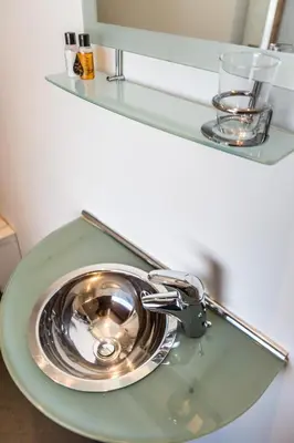 a silver sink sitting on top of a green counter at Eastkirk in Corrie