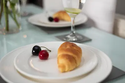 a plate with a pastry and cherries on a table at PREMIER - Wishaw En-Suite Apartment in Wishaw