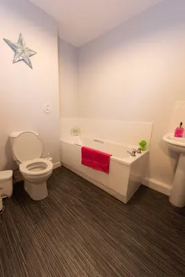 a bathroom with a tub and a toilet and a sink at PREMIER - Wishaw En-Suite Apartment in Wishaw