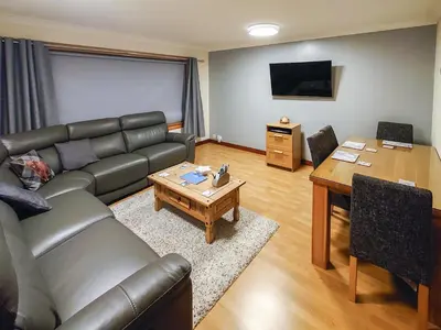 a living room with a couch and a table at The Hoolit in Crieff