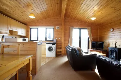 a living room with a kitchen and a living room at Concraig Lodge in Crieff