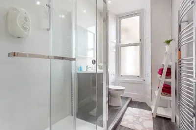 a bathroom with a glass shower and a toilet at Stunning 2-Bed Apartment in Central Edinburgh in Edinburgh