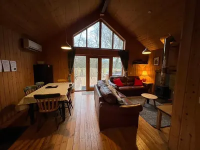 a living room with a couch and a table at Fern Lodge in Dalavich