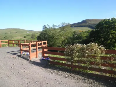 a fence with flowers on the side of a road at Rockfoot B&B in Fintry