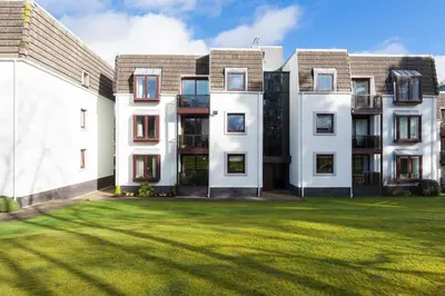 an apartment building with a lawn in front of it at 45 Guthrie Court, Fantastic top floor apartment next to Gleneagles in Auchterarder