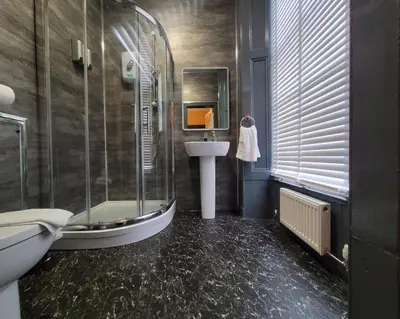 a bathroom with a shower and a sink and a tub at Stay - Gilmore Guesthouse in Edinburgh