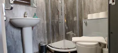 a bathroom with a shower and a sink and a toilet at Stay - Gilmore Guesthouse in Edinburgh
