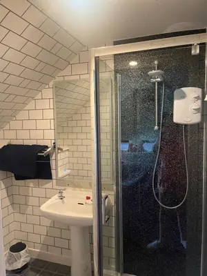 a bathroom with a shower and a sink at Dellwood Hotel in Campbeltown