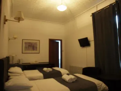 a hotel room with two beds and a window at Argyll Arms Hotel in Campbeltown