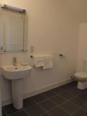 a bathroom with a sink and a toilet at Argyll Arms Hotel in Campbeltown