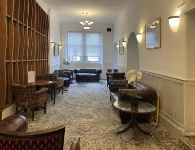 a waiting room with couches and chairs and tables at Argyll Arms Hotel in Campbeltown