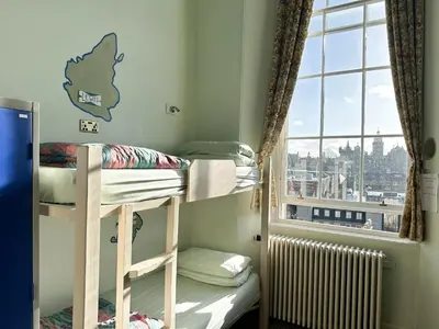 a dorm room with bunk beds and a window at Castle Rock Hostel - Adults Only in Edinburgh