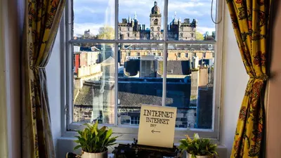 a window with a view of a city at Castle Rock Hostel - Adults Only in Edinburgh