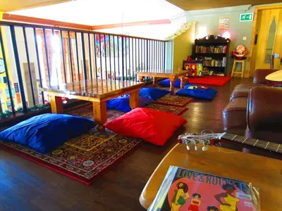 a living room with a table and pillows on the floor at Castle Rock Hostel - Adults Only in Edinburgh