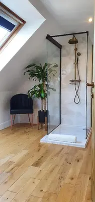 a glass shower in a room with a potted plant at The Sleeping Dog Room at The Grumpy Schnauzer BnB Huge Room, Luxe Suite, Private Hot Tub, Breakfast, Gym, Games Room, Farm Stay, Amazing in Airdrie