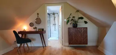 a room with a desk and a door with a table and a chair at The Sleeping Dog Room at The Grumpy Schnauzer BnB Huge Room, Luxe Suite, Private Hot Tub, Breakfast, Gym, Games Room, Farm Stay, Amazing in Airdrie